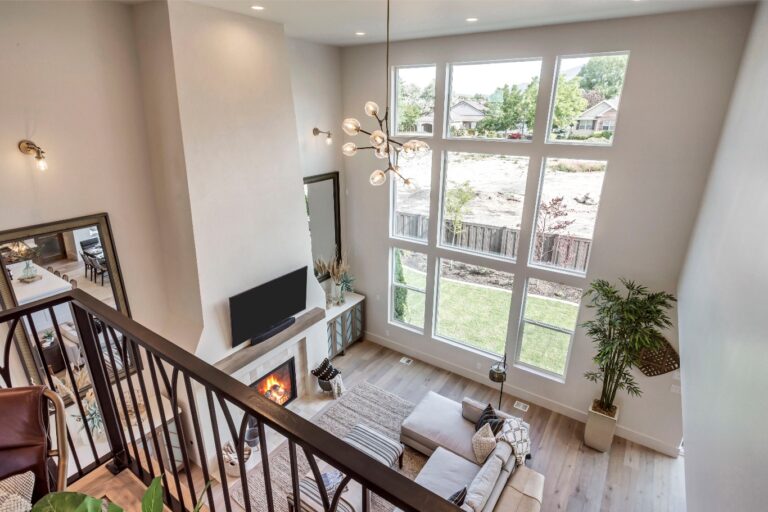 The room is large and well-lit with high ceilings and a fireplace.