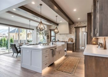 The room is a modern kitchen with white cabinets and brown countertops.